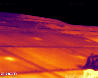 Daytime solar panel thermal imaging showing overheating cell indicating a defect